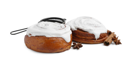 Tasty cinnamon rolls with cream and spices isolated on white