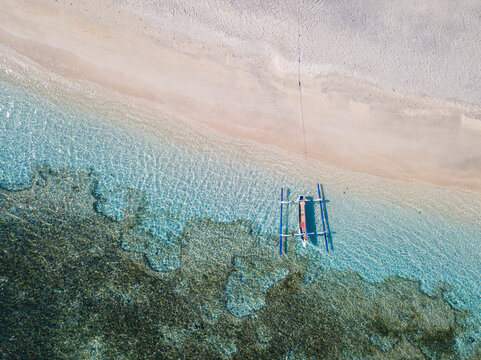 Drone view of outrigger moored at beach in Bali, Indonesia