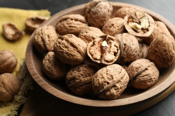 Fresh walnuts in shells on table, closeup
