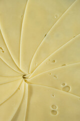 Semi-hard cheese close-up, thin slices, top view