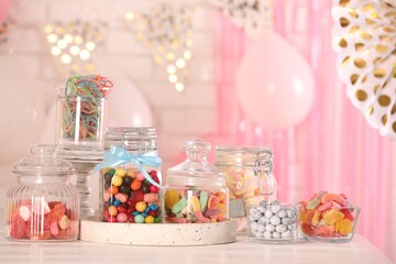 Candy bar. Many different sweets on white wooden table in festive decorated room