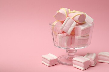 Tasty marshmallows in glass dessert bowl on pink background, closeup. Space for text
