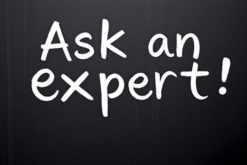 Fototapeta premium White text Ask an expert on black chalkboard