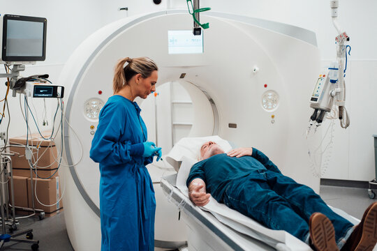 Doctor consulting patient during MRI scan in a clinic