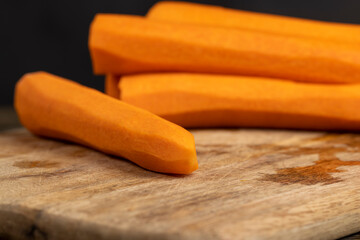 peeled orange carrots on the table during cooking