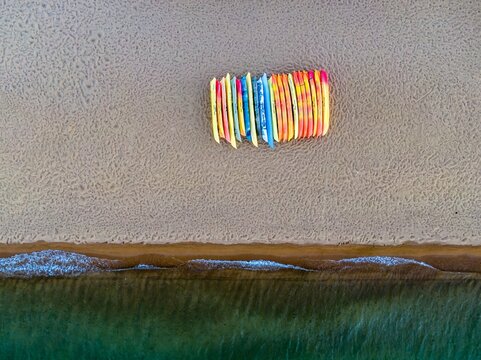 Colorful kayaks lined up on a sandy beach. Perfect for a relaxing day on the water. Baldwin Beach, South Lake Tahoe, California, USA