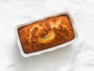 Ricotta lemon pound cake in a baking dish on a light background top view