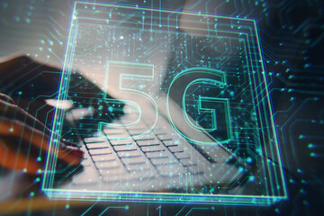 5G technology digital overlay on laptop keyboard background.