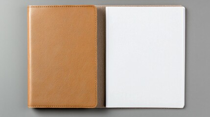 Fototapeta premium Brown leather notebook next to an open blank page on a gray background.