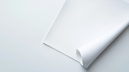 Close-up of blank white paper with corner curl on light background, perfect for design or text overlay.