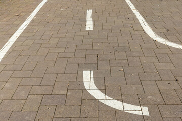 Parking lot with curved lines on a sunny day creates an interesting geometric pattern