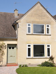 Exterior view of a beautiful house and garden on a street in an English town