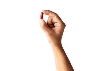 Male hand holding a red pill isolated no background