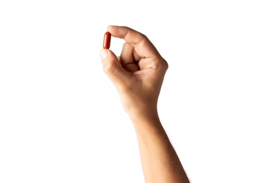 Male hand holding a red pill isolated no background