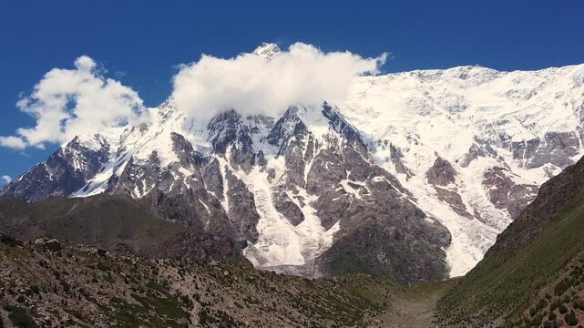 Majestic Nanga Parbat, the ninth highest mountain, rises above the rugged Rupal Valley in Gilgit-Baltistan, Pakistan, showcasing breathtaking natural grandeur