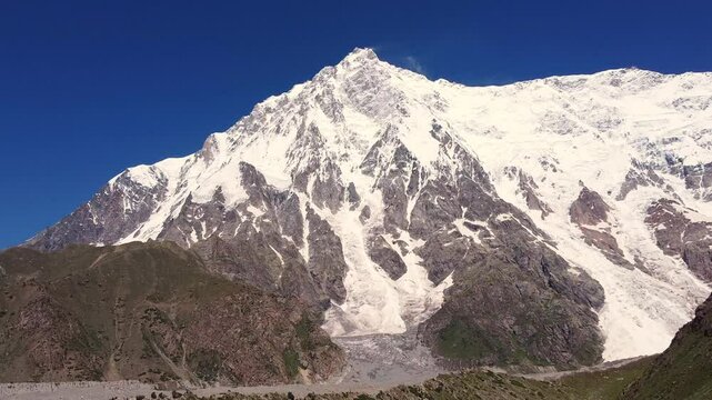 Majestic Nanga Parbat, the ninth highest mountain, towers over Rupal Valley in Gilgit Baltistan, Pakistan, draped in snow and ice