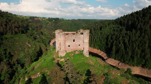 aerail shot around Alleuze Castle at sunset, Cantal departement, auvergne rhone alpes region, france