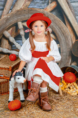 ittle red riding hood girl. a beautiful little girl in a red riding hood costume with an accordion...