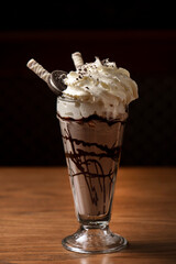 Chocolate milkshake with whipped cream and chocolate wafer sticks