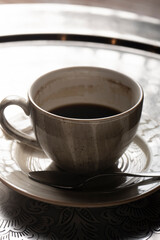 A cup of unfinished coffee on a tray.