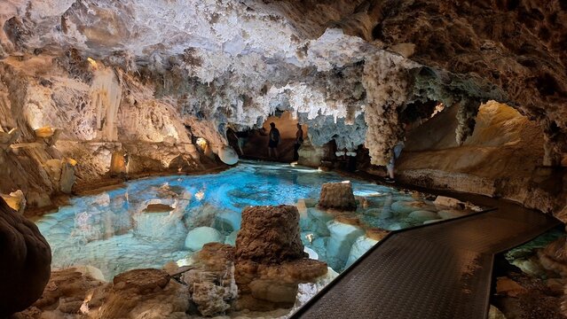 Stunning interior of Las Grutas de las Maravillas with stalactites, stalagmites, and lakes.