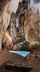 Stunning interior of Las Grutas de las Maravillas with stalactites, stalagmites, and lakes.
