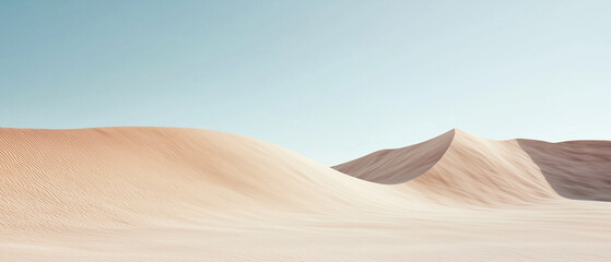 Sand dunes under clear blue sky with gentle curves and soft textures