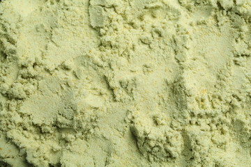 Dry wasabi powder as background, top view