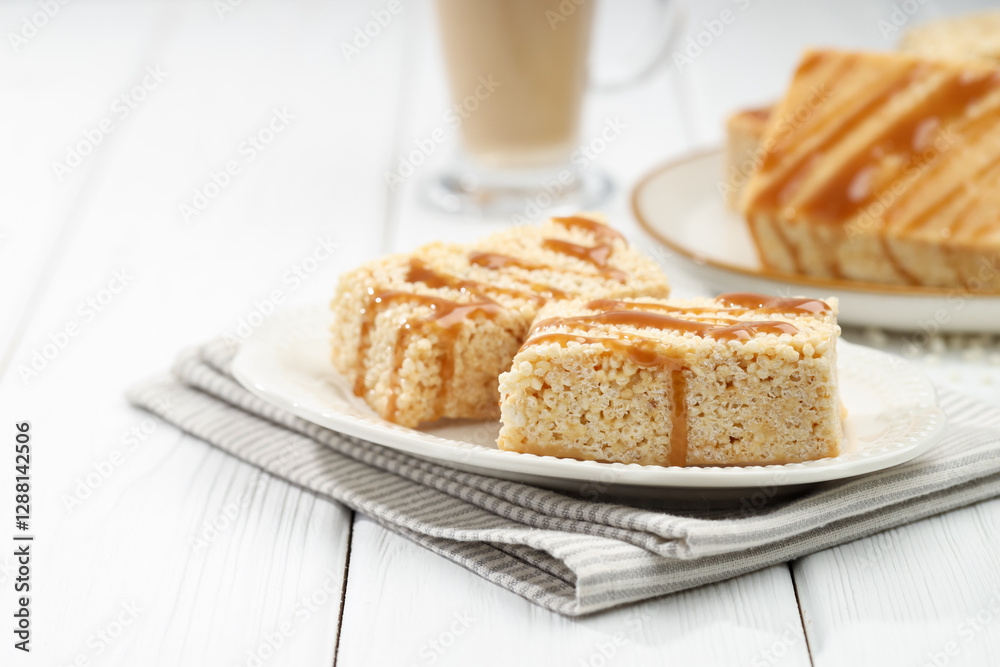 Wall mural Delicious caramel puffed rice bars on white wooden table, closeup