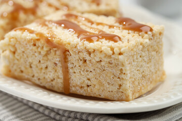 Delicious caramel puffed rice bars on table, closeup