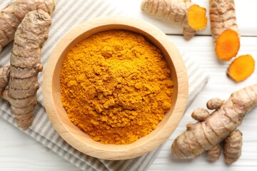 Aromatic turmeric powder and fresh roots on white wooden table, flat lay