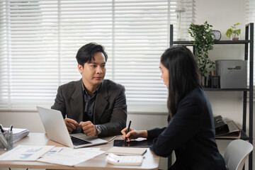 Diverse professionals discussing financial strategies in a bright office environment.
