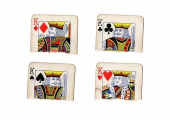 Torn quarters of old playing cards showing the same value on a white background.