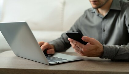  A person is using a laptop and a cell phone at the same time 
