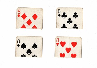 Torn quarters of old playing cards showing the same value on a white background.