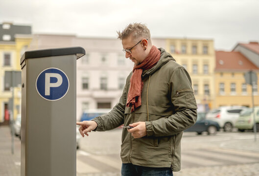Man Uses Parking Meter: Types License Plate Number