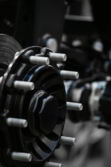 Naklejka premium close up of black wheel axle with many bolts