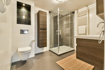 Sleek modern bathroom featuring a glass shower, stylish cabinetry, and contemporary fixtures that create a luxurious atmosphere.