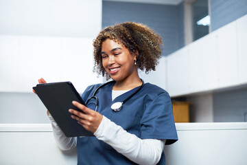 Smiling Healthcare Professional Using Digital Tablet in Modern Office