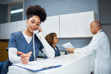 Healthcare Professionals Collaborating at a Clinic Reception Desk