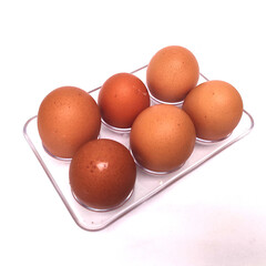 six chicken eggs in an egg tray