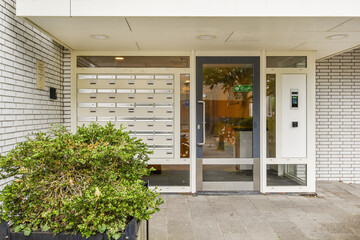 Modern mailbox entrance with glass door