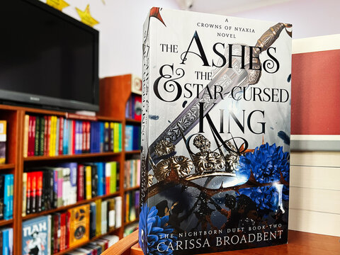 Bookstore display featuring 'The Ashes and the Star-Cursed King' by Carissa Broadbent
