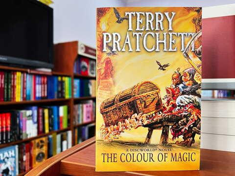 Fantasy book cover of Terry Pratchett's The Colour of Magic in a library