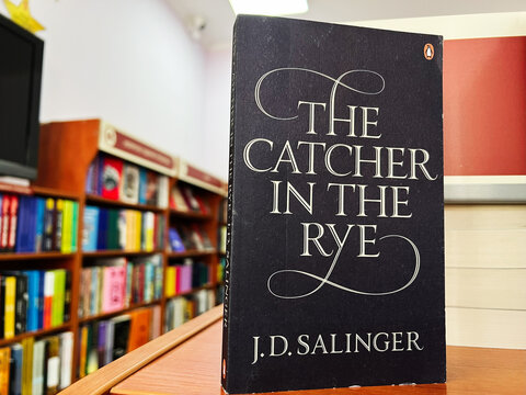 The Catcher in the Rye book by J.D. Salinger on bookshelf in store