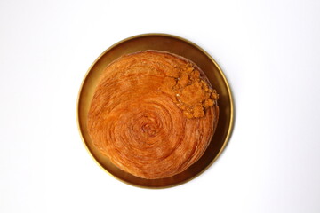 Top view or croissant roll or timbering on round dish and white background.