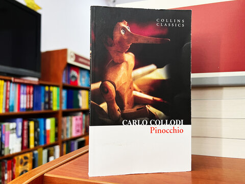 Carlo Collodi's Pinocchio Book Displayed in a Bookstore Background