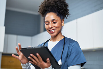 Smiling Healthcare Worker Using a Digital Tablet in a Modern Medical Setting