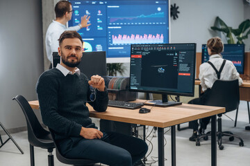 Using 3d printing software. Designer team are together in the office