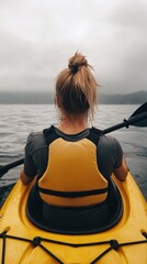 Fototapeta premium A Young Adult Caucasian Female Kayaker Paddling on a Serene Lake Under Overcast Skies, Capturing the Spirit of Adventure and Connection with Nature